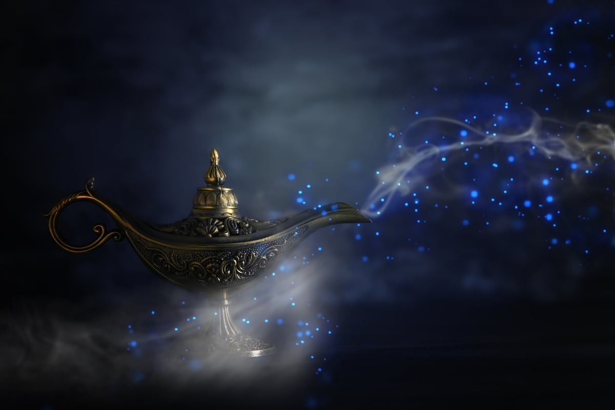 Image of magical mysterious aladdin lamp with glitter sparkle smoke over black background. Lamp of wishes.